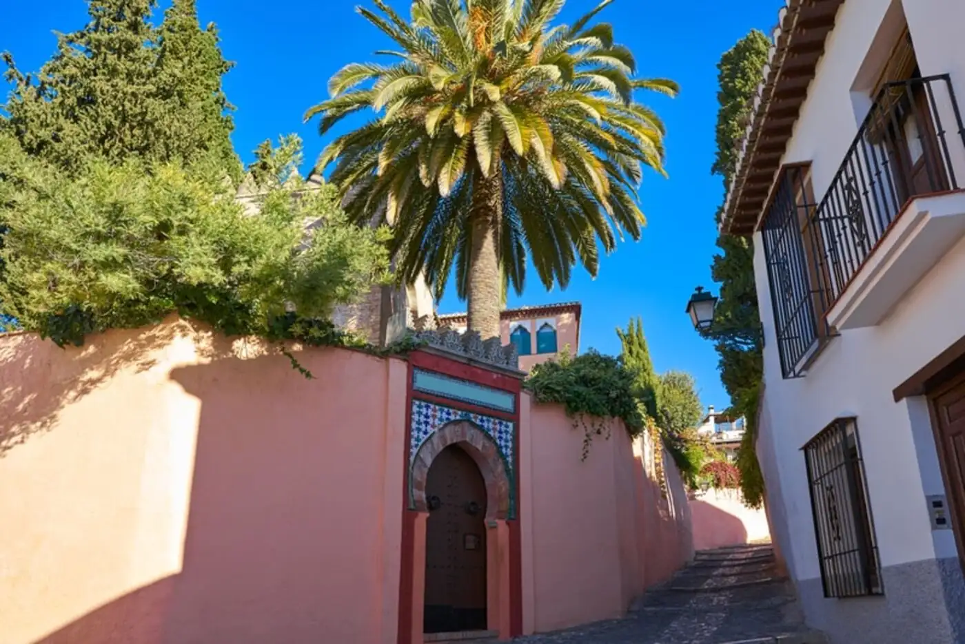 Moorish-style doorway and palm tree in the Albaicín quarter of Granada — historic Arab and Jewish district