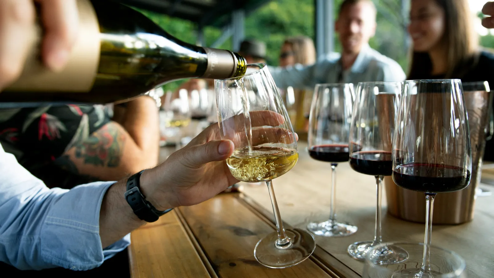 Andalusian wine tasting with a glass of fino sherry being poured at a sunlit table