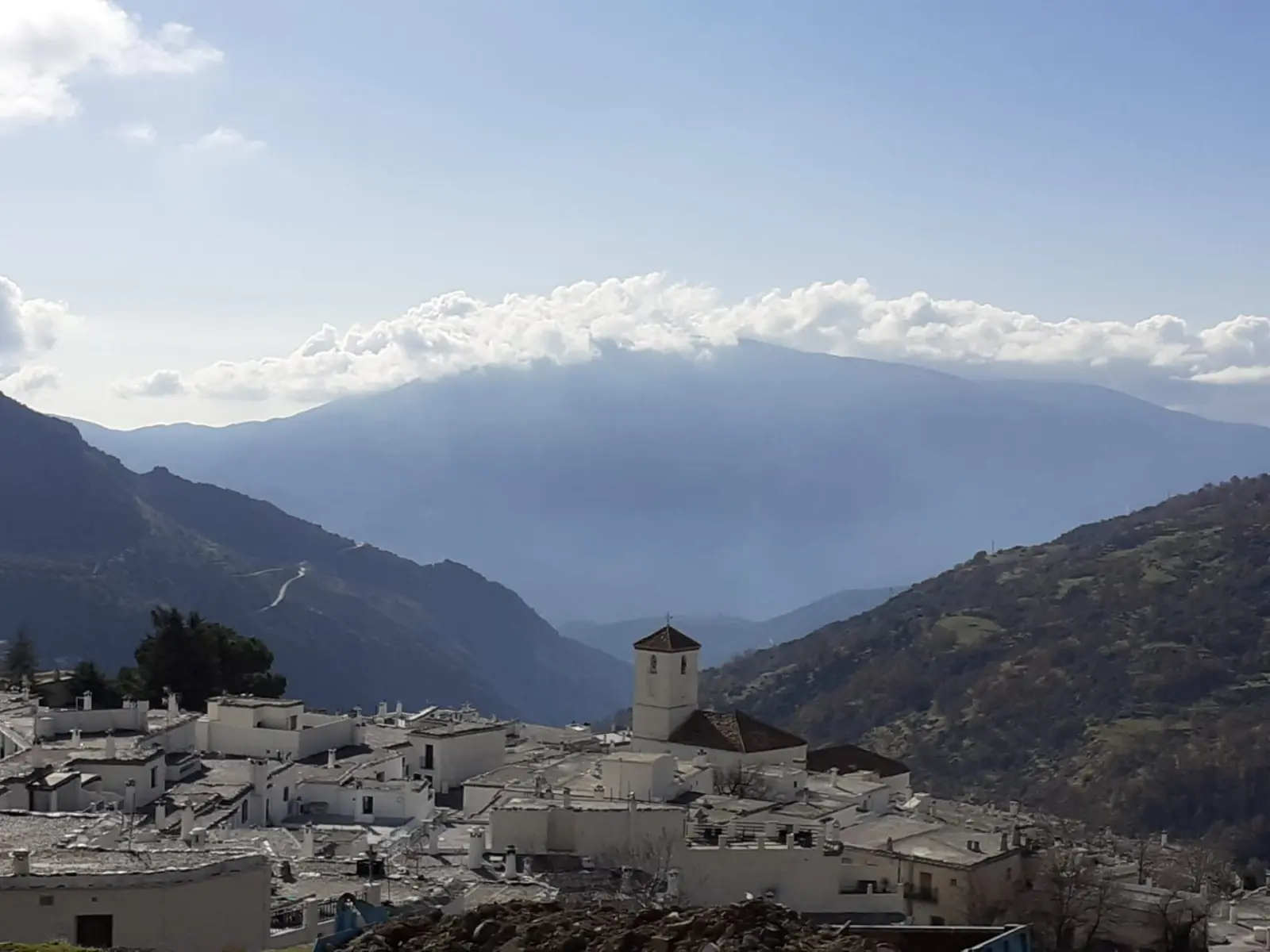 Whitewashed village of Capileira in the Alpujarra with the Sierra Nevada mountains rising behind