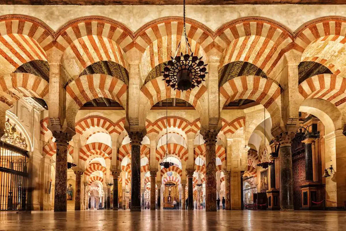 Iconic red and white double arches and forest of columns inside the Mosque-Cathedral of Cordoba