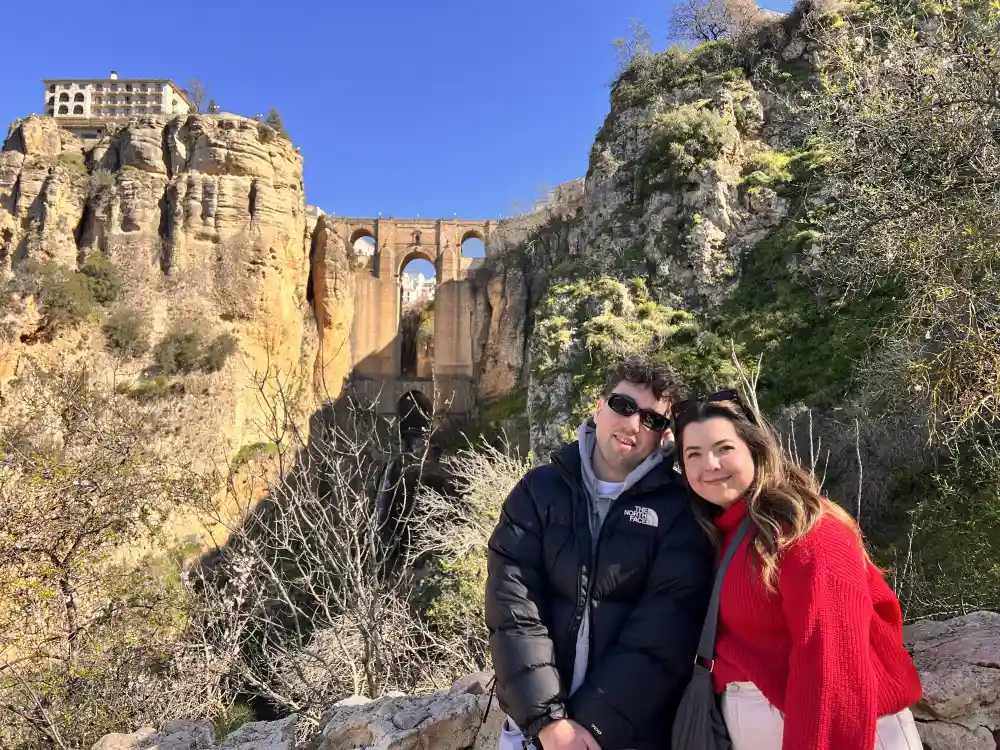 Travelers enjoying a private Ronda day trip from Malaga at a viewpoint overlooking the Puente Nuevo and El Tajo gorge