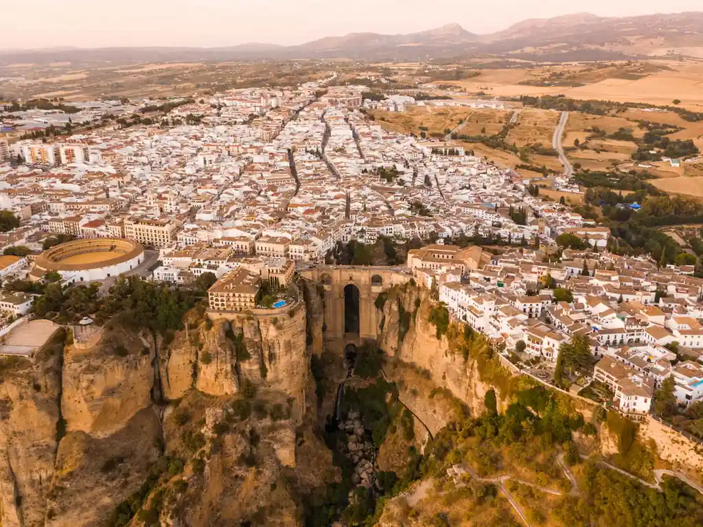 Panoramic view from Ronda over the Serranía mountains, vineyards and olive groves under a dramatic sky