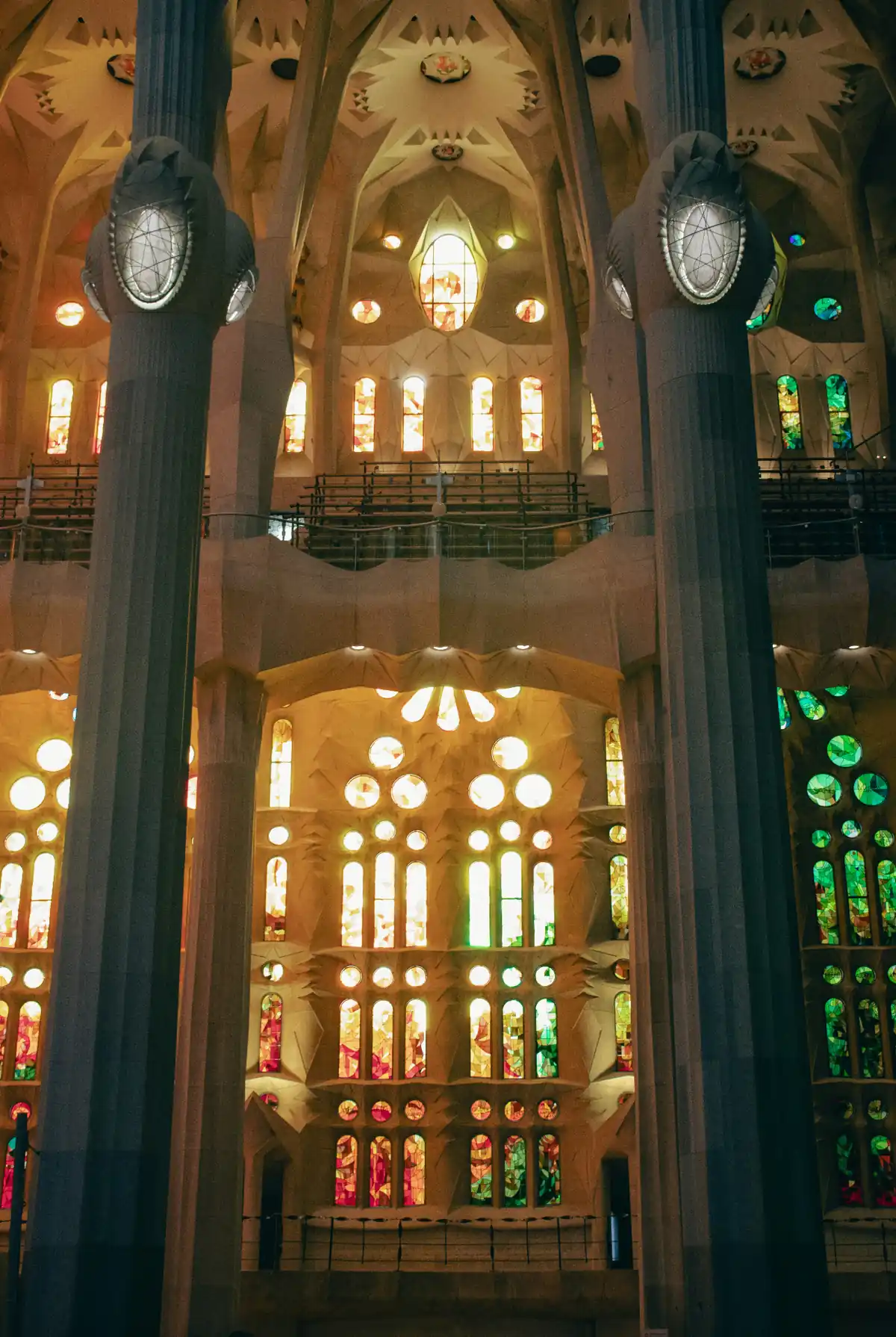 Interior of the Sagrada Familia with tree-like columns and colorful stained glass light
