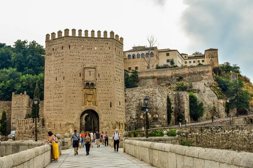 Stone tower and gate of Puente de Alcántara bridge leading into Toledo's old city